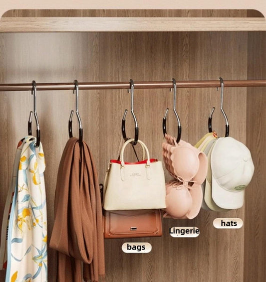 Wardrobe storage hook rack with black hangers holding hats, bags, and lingerie items