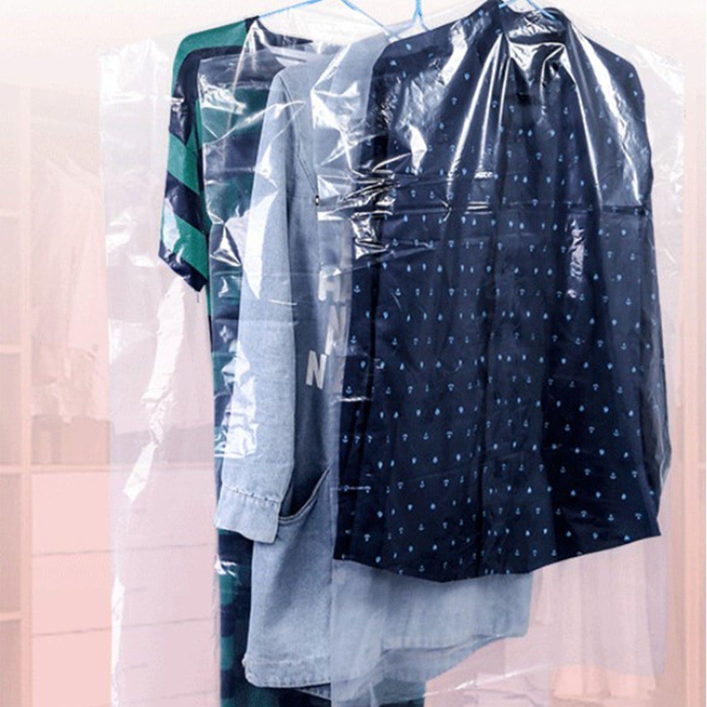 Semi-transparent hanging garment bag over dark clothing, with top hanger hook