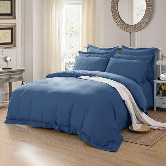 Blue duvet cover with matching pillow shams set on bed, side view