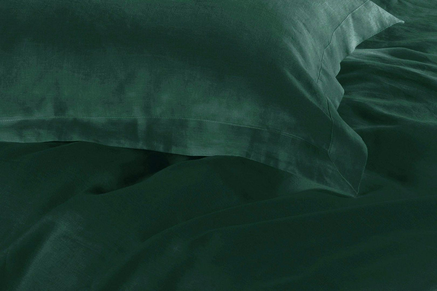 Dark green fabric close-up with soft wrinkle texture
