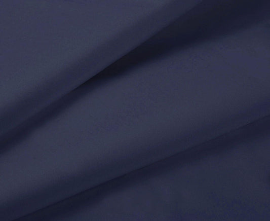 Midnight blue fitted sheet fabric close-up with smooth surface and soft drape