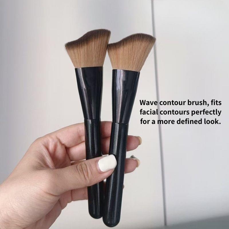 Set of two contour brushes with brown bristles and black handles, held in hand