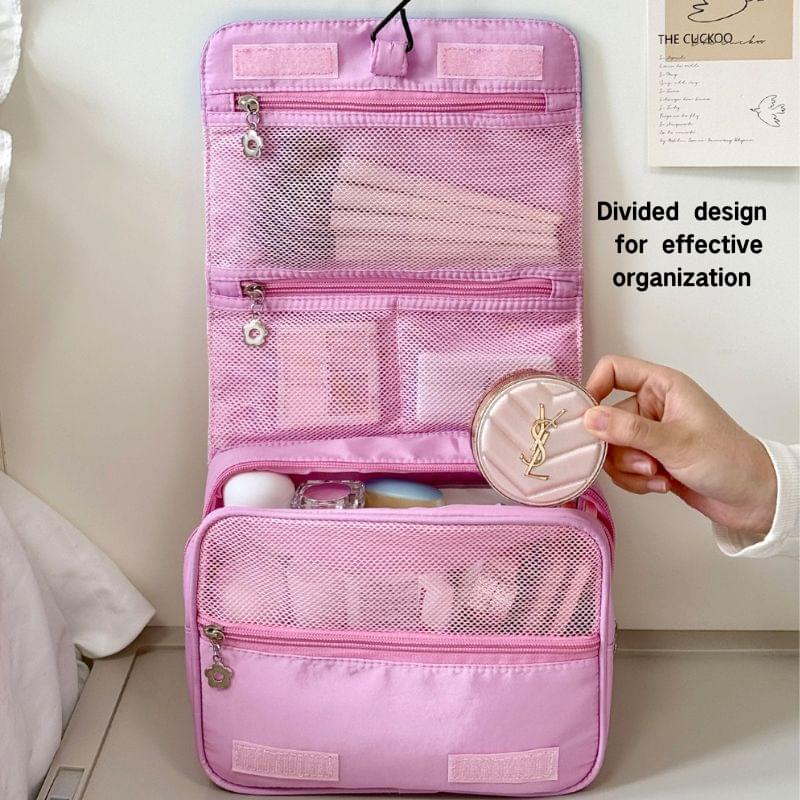 Pink divided makeup bag with zip pockets and YSL-logo coin charm