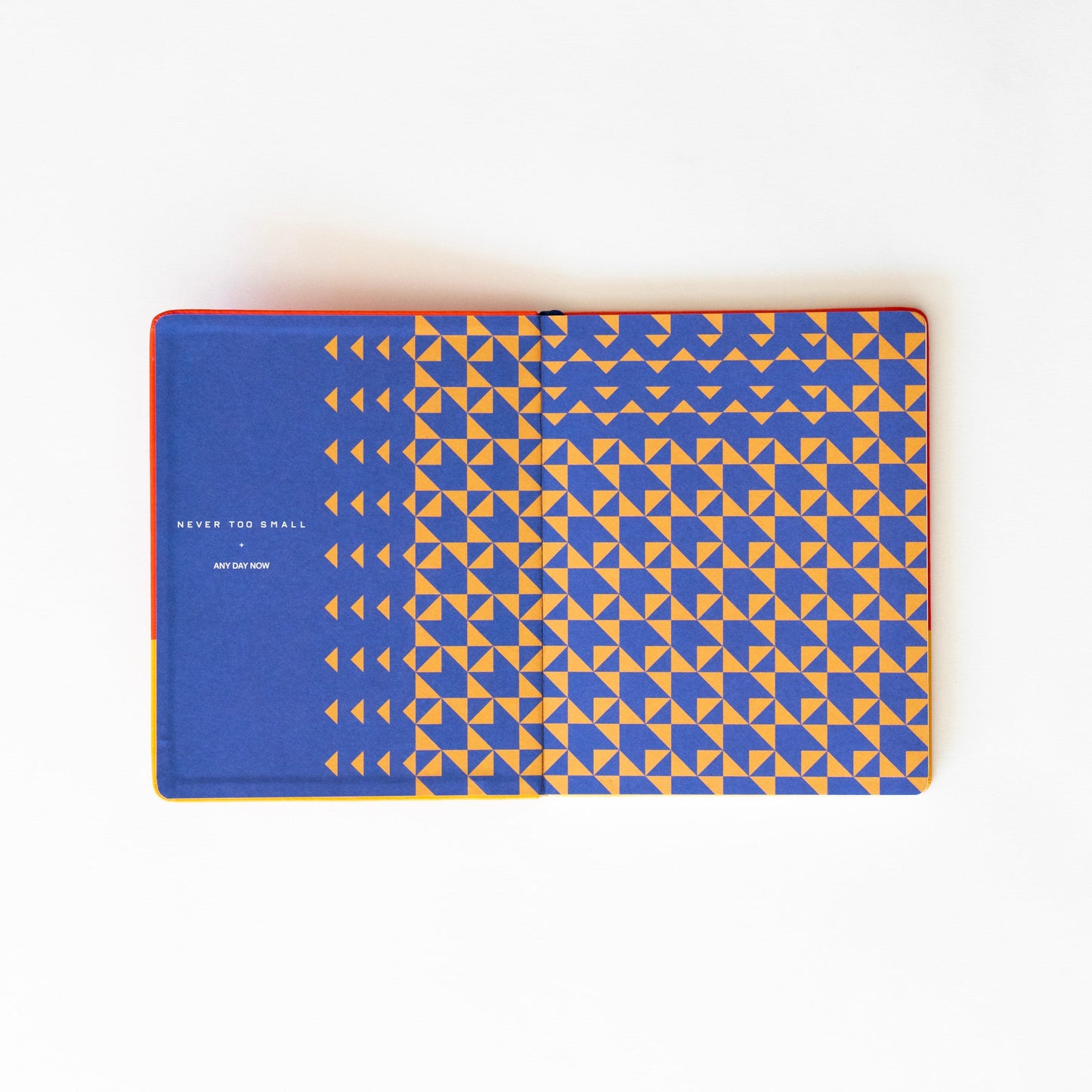 Blue notebook inside pocket with geometric pattern and small-arrow border