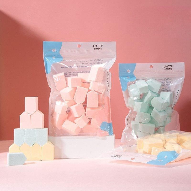 Assorted wedge makeup sponges in pastel colors, packaged set of small sponge puffs