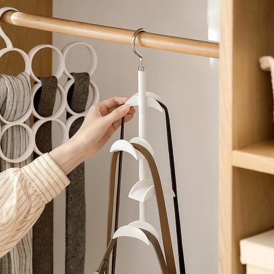Two 4-tier rotating closet hooks on a rod, one white and one black