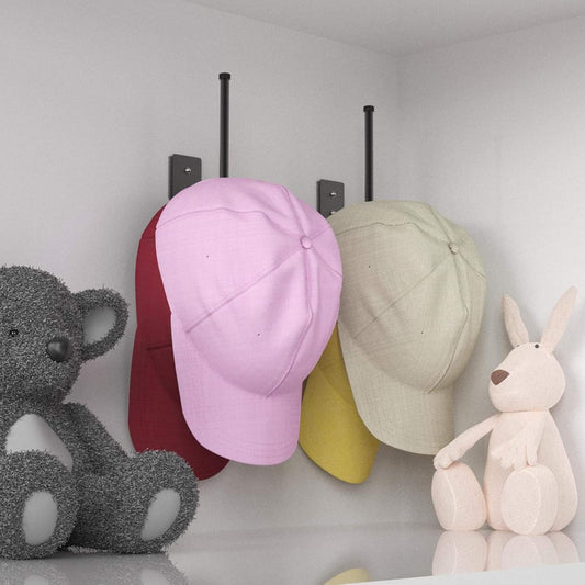 Wall-mounted cap hat rack holding baseball caps, purple and light tan, black posts
