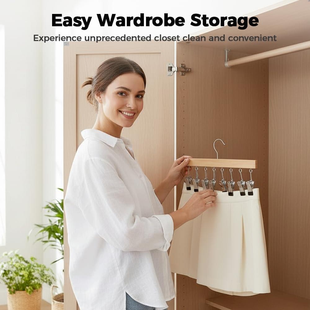 Wooden legging hanger with multiple clips held in hand by smiling person