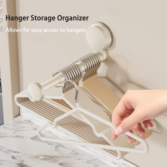 Wall-mounted telescopic hanger organizer with spring rails holding multiple plastic hangers
