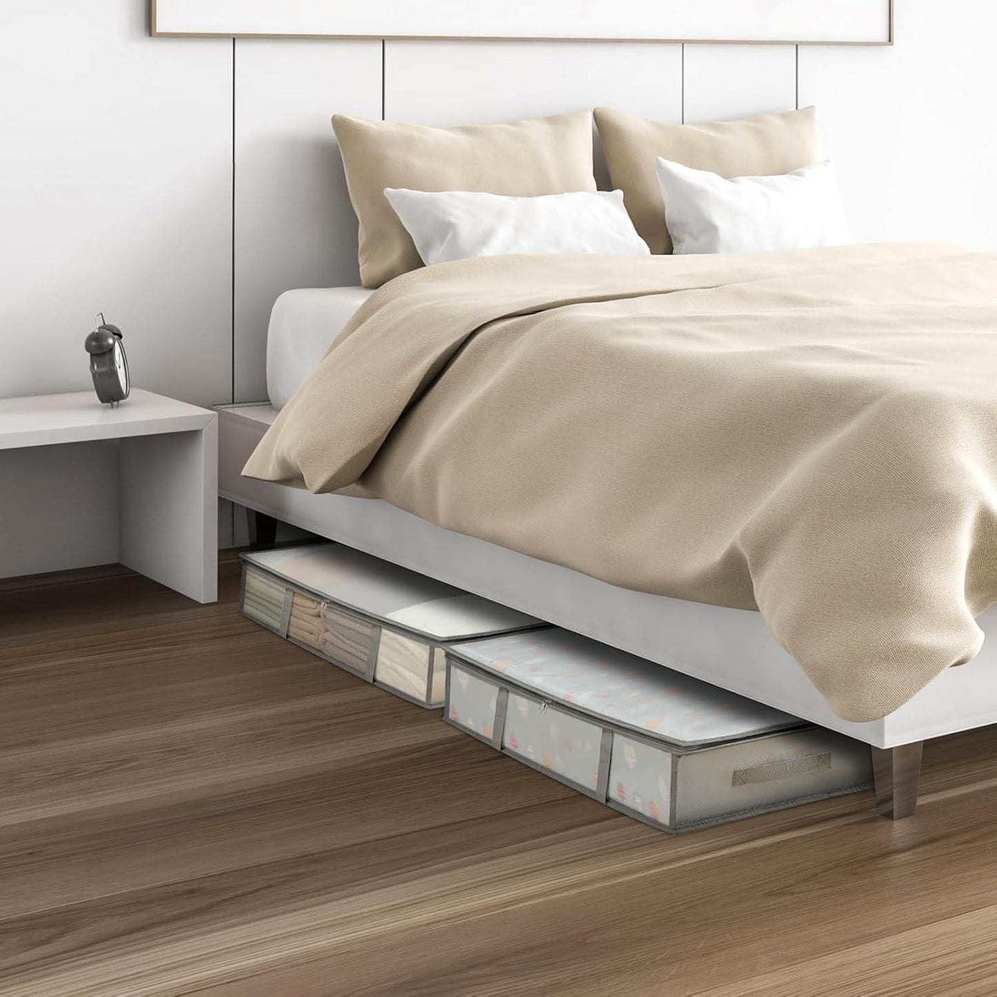 Under-bed storage bins with clear fronts under a bed, holding neatly folded bedding
