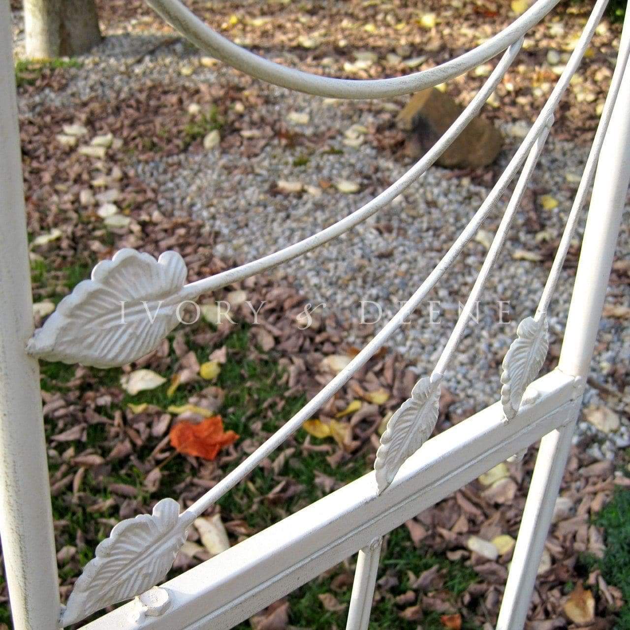 Distressed cream metal garden arch crossbar with leaf medallion details