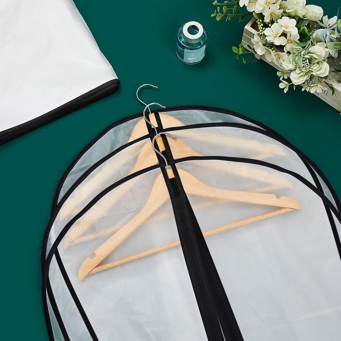 Clear hanging garment bag with black hanger strap and transparent cover