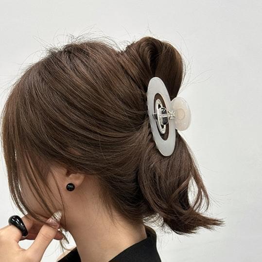 Medium hair claw clip with white oval acetate and silver diamond-style centerpiece detail