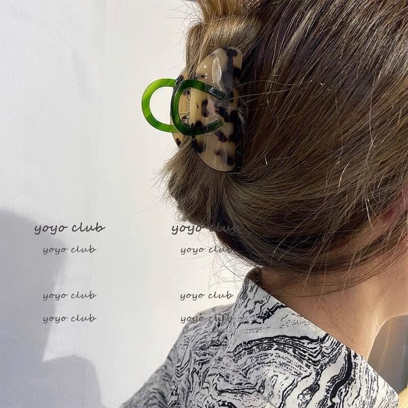 Green tortoiseshell acrylic hair claw clip with handle, medium, on hair