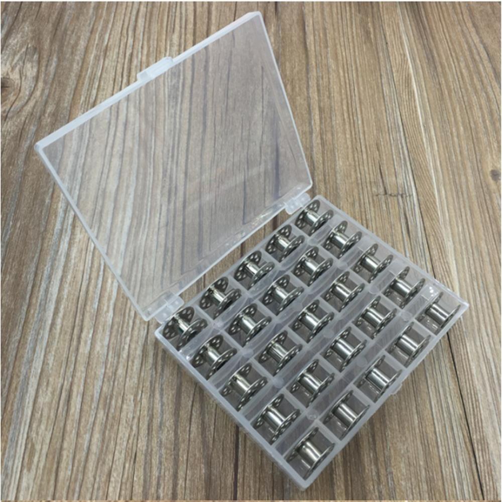 Silver sewing machine bobbins in clear open storage case with divided slots