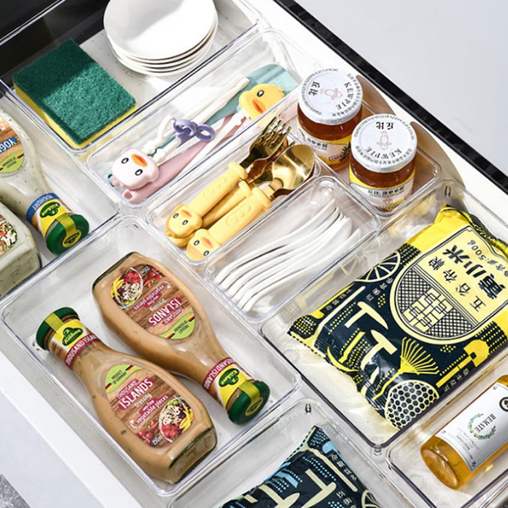 Transparent organizer drawer insert with multiple clear compartments holding small items