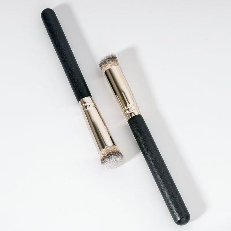 Two flat-top concealer brushes with black handles and silver ferrules