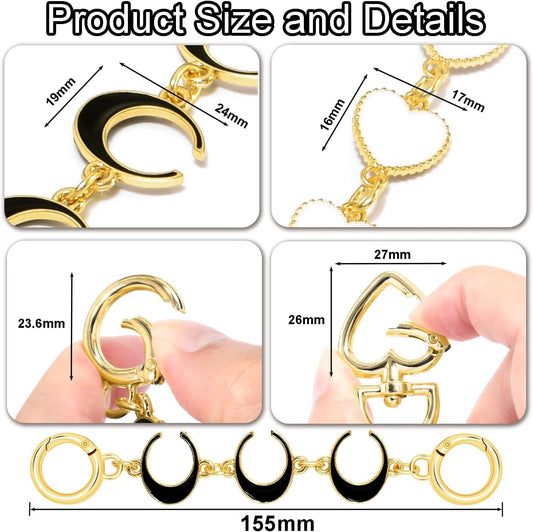 Gold and black purse chain extender detail with C hooks and heart charms