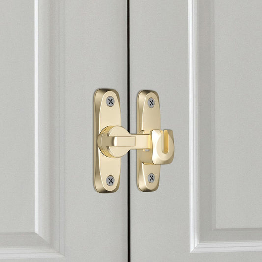 Gold flip door latch lock installed on door with mounting screws