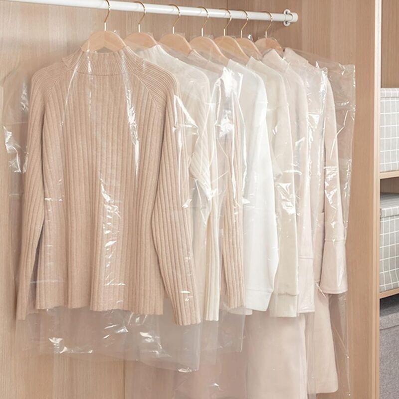 Transparent coat and suit dust covers on multiple hangers, crinkled fabric