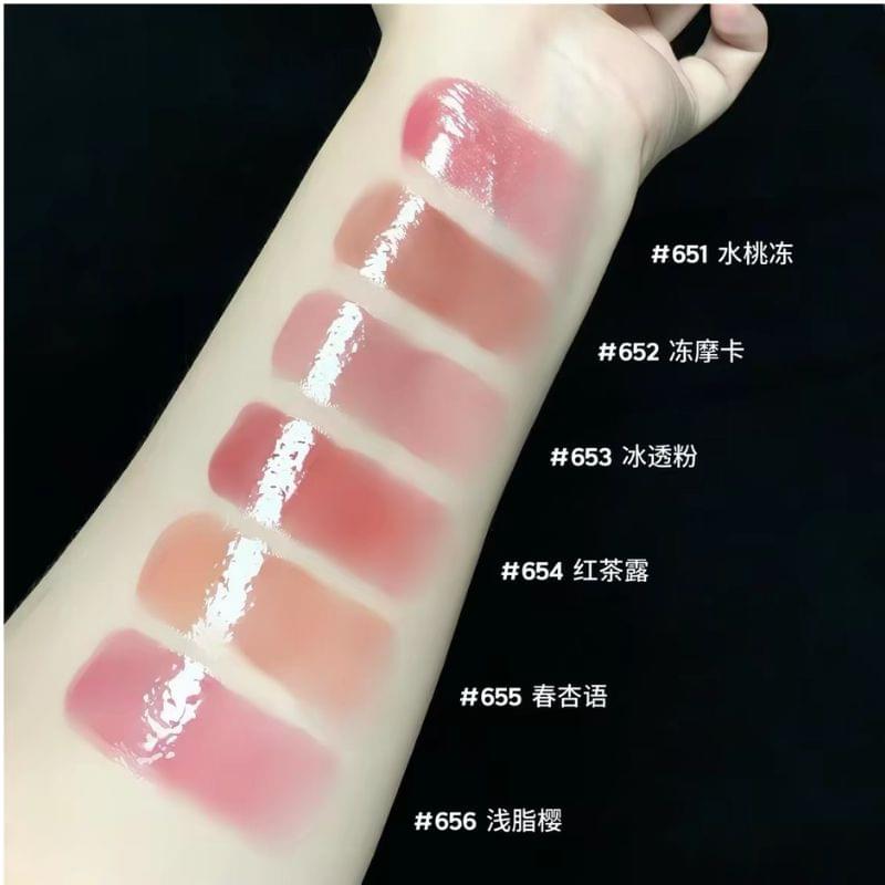 Lip gloss shade swatch strip on skin, multiple glossy transparent colors