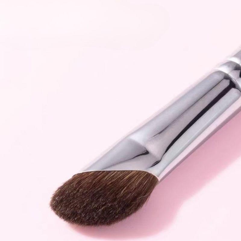 Small angled nose shadow brush with silver handle and dense brown bristles