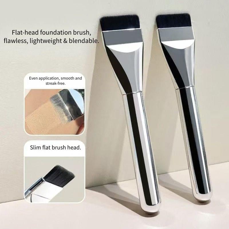 Two flat foundation brushes with black bristles and silver handles, angled side by side