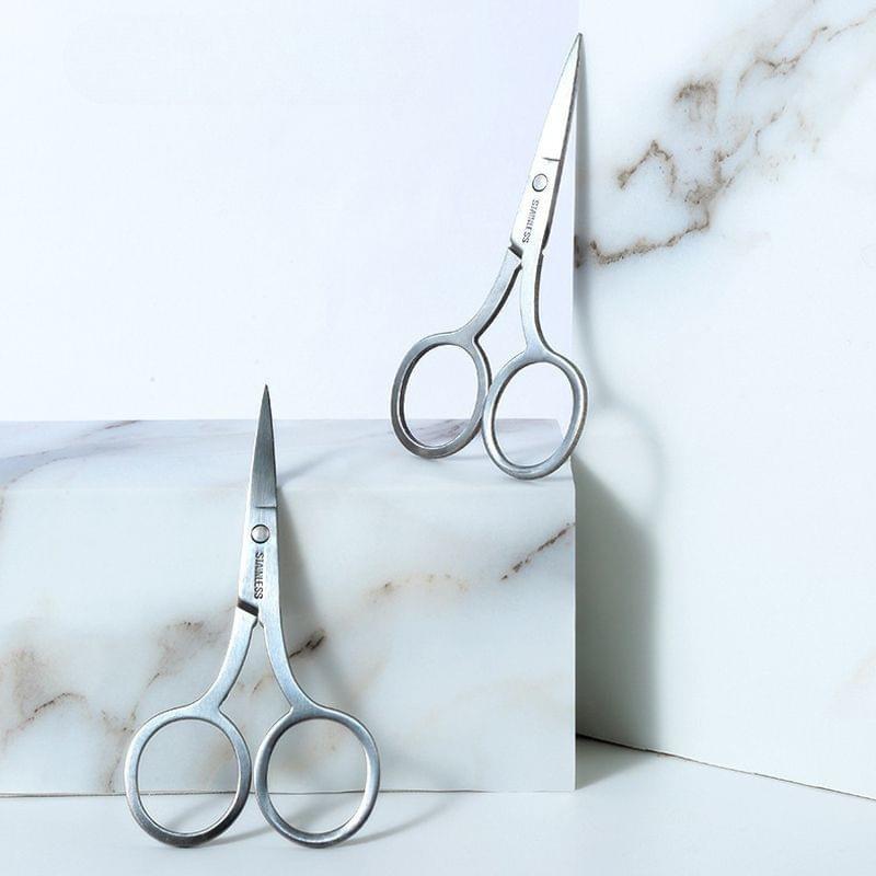 Pair of stainless steel beauty scissors with pointed tips and circular finger rings