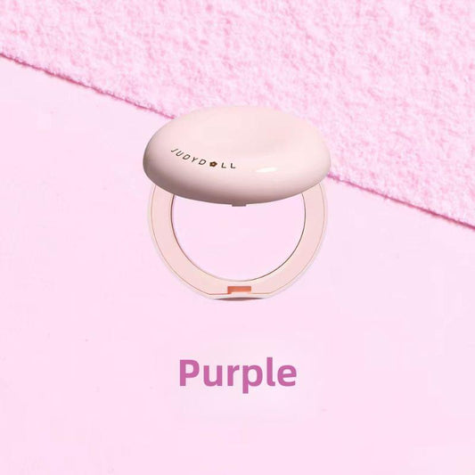 Purple-toned pressed setting powder compact, closed case with circular powder window.