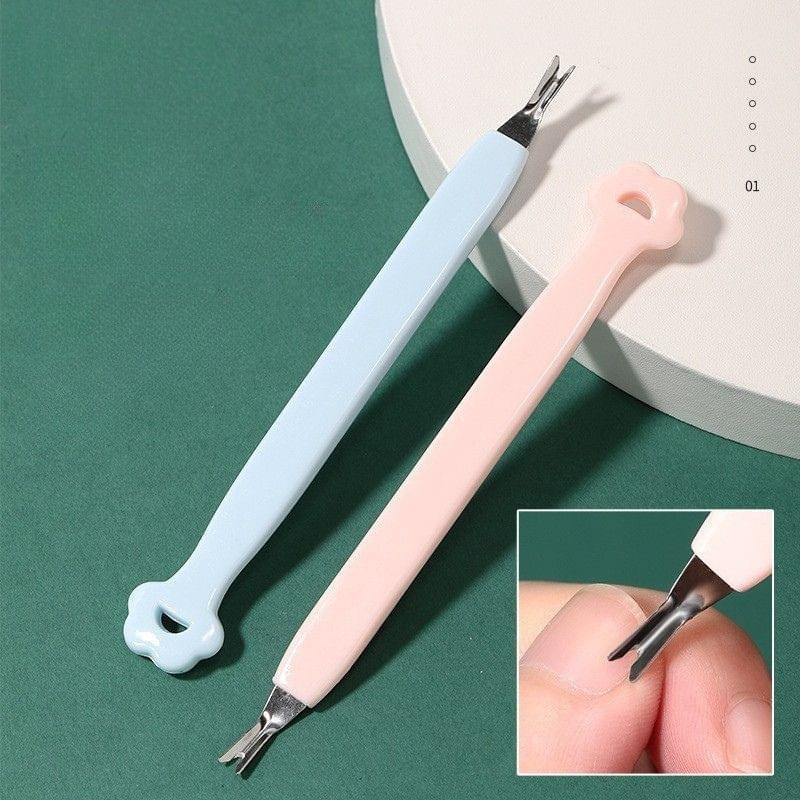 Pink and blue manicure tools with metal tips: cuticle pusher and nail clipper
