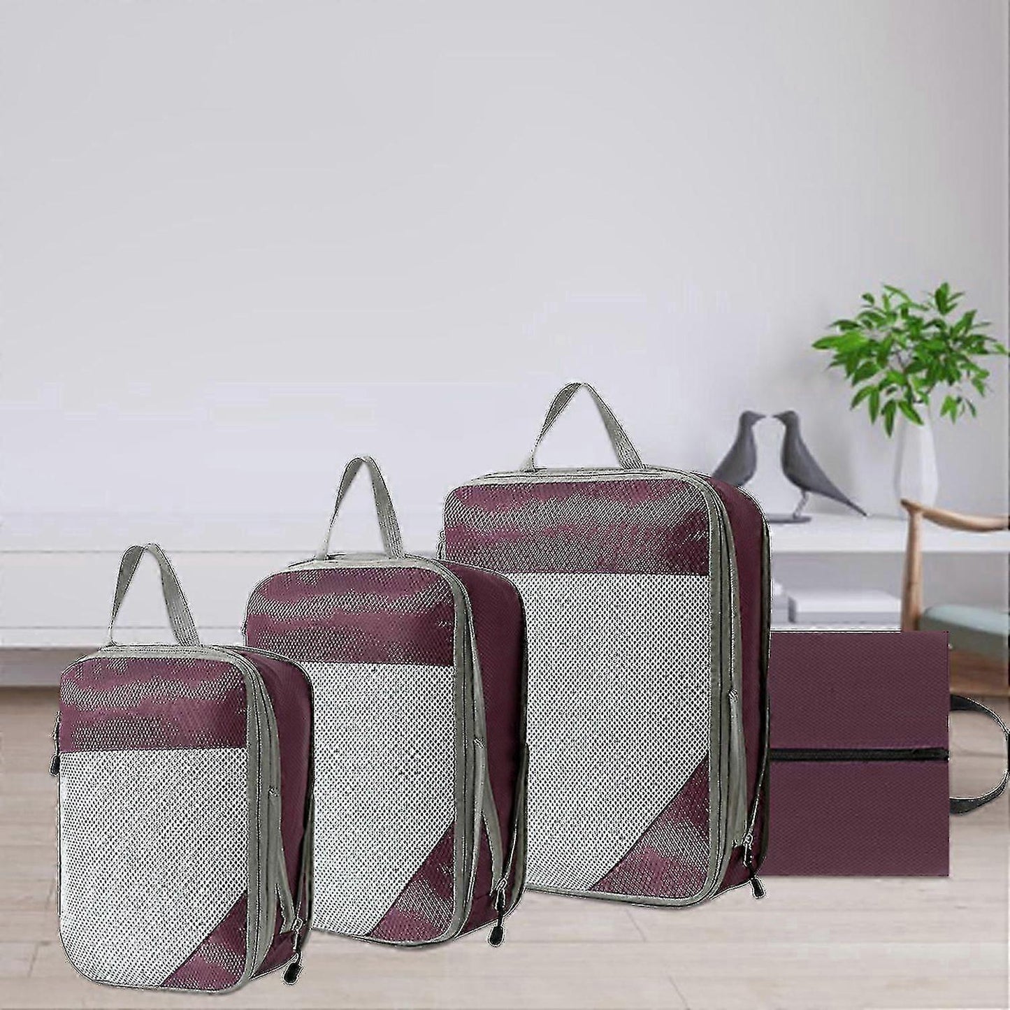 Compression packing cubes in maroon and gray mesh, three cube bags with handles.