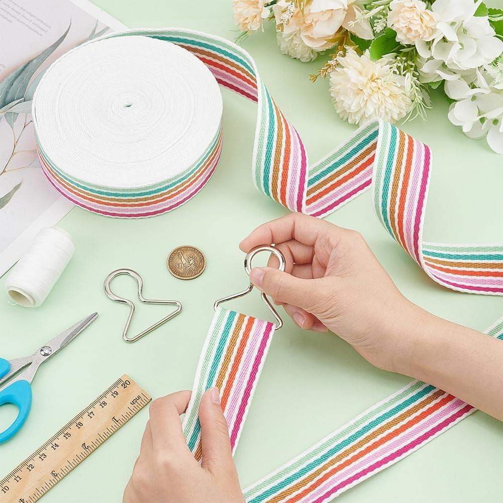 Arrow-pattern striped ribbon strip in rainbow pastel on white base with navy zigzags