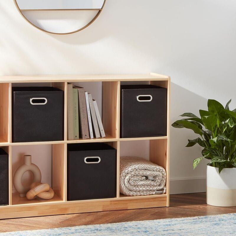 Black fabric storage cube with oval grommet handle on shelf cubby