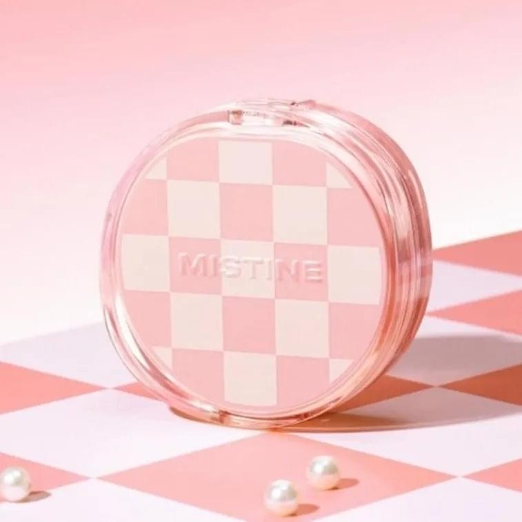 Mistine air cushion compact with clear round case and pink checker-pattern lid