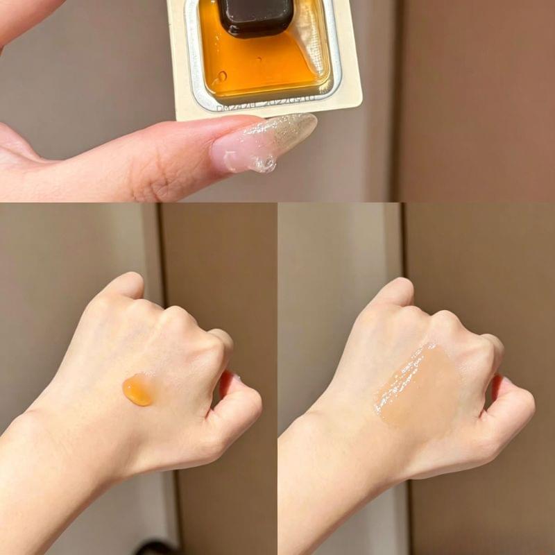 Orchid oil swatch on hands with glossy drop texture