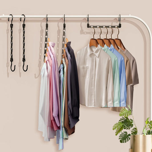 Black plastic hanger set on a closet rod, holding shirts in assorted colors