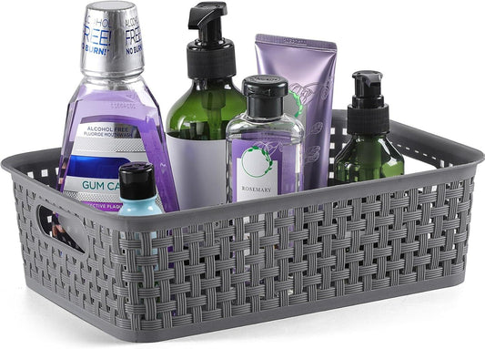Grey woven plastic organizer basket with cutout handles holding bottles
