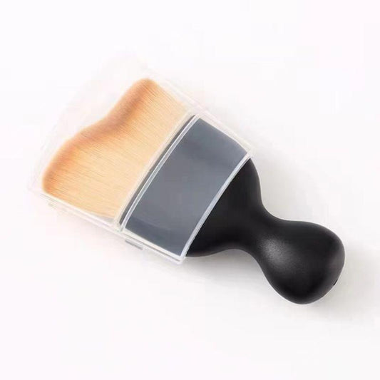 Angled contour makeup brush with golden bristles and black handle, dual-wave shape