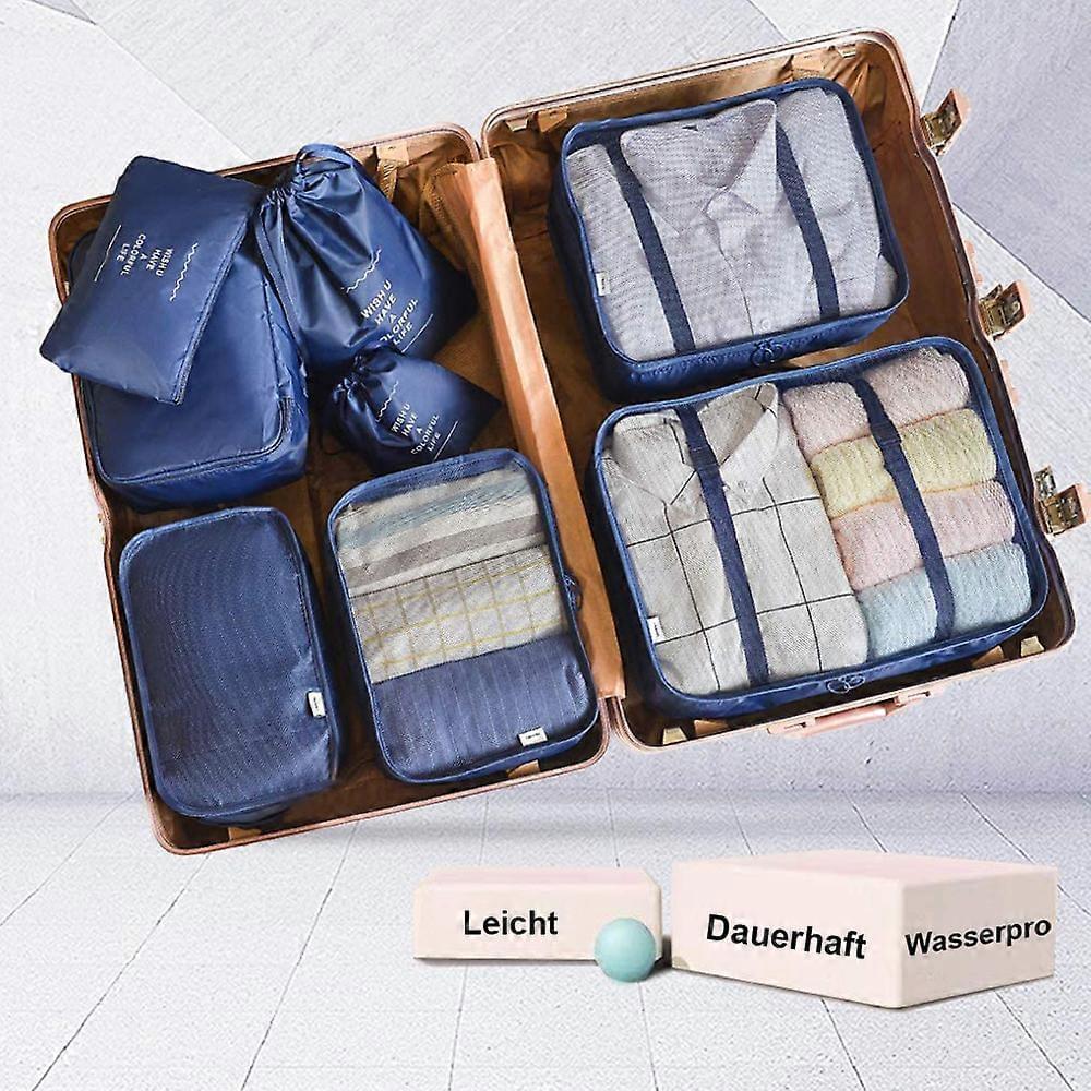 8-piece blue packing cube set in an open suitcase with multiple compartments