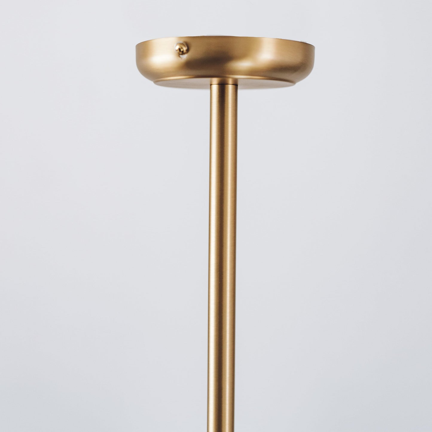 Gold metal pendant light canopy and straight rod for suspension