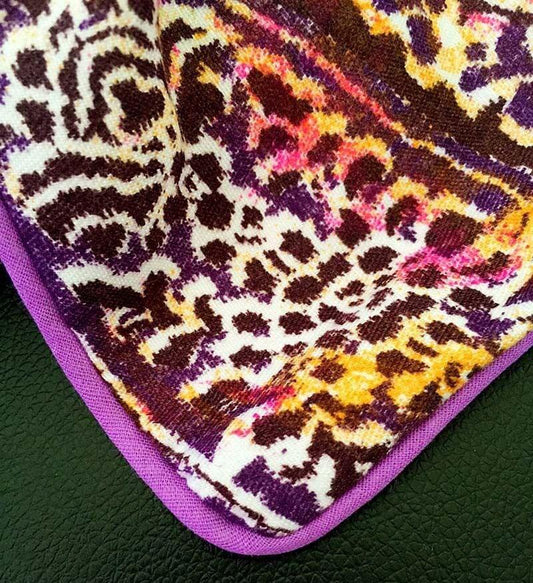 Purple duvet quilt cover with multicolor abstract paisley pattern, close-up corner