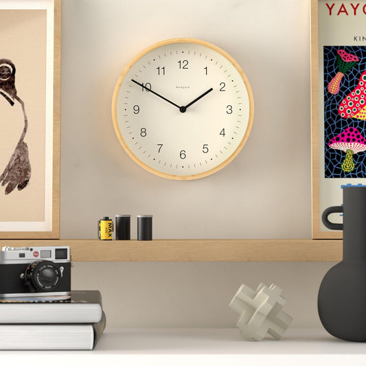 Wall clock with pale wood rim and white dial, black minute and hour hands