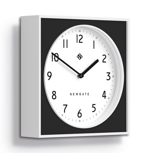 Black square wall clock with white dial and visible frame depth; burger & chips hands