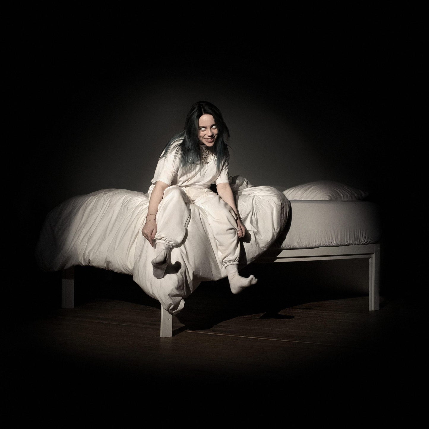 Vinyl album cover featuring Billie Eilish sitting on a bed, wearing a light outfit.