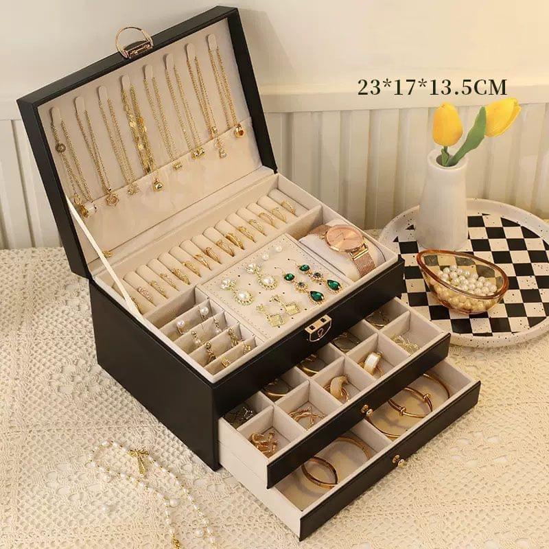 Open black lockable jewelry box with ring, earring and bracelet compartments