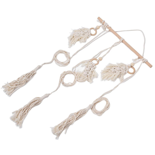 Cotton rope macrame wall rack with wooden dowels, ring loops, and tassel charms