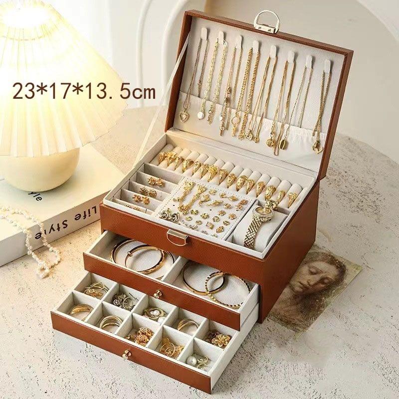 Brown lockable jewellery box with open lid and three drawers, 23×17×13.5 cm.
