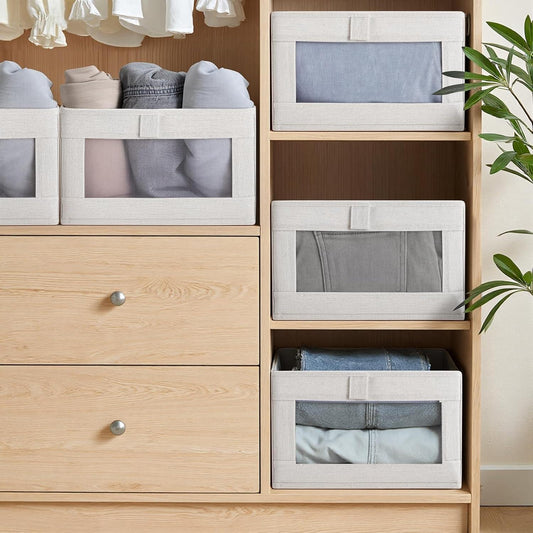 White fabric storage bins with clear front panels for folded clothes
