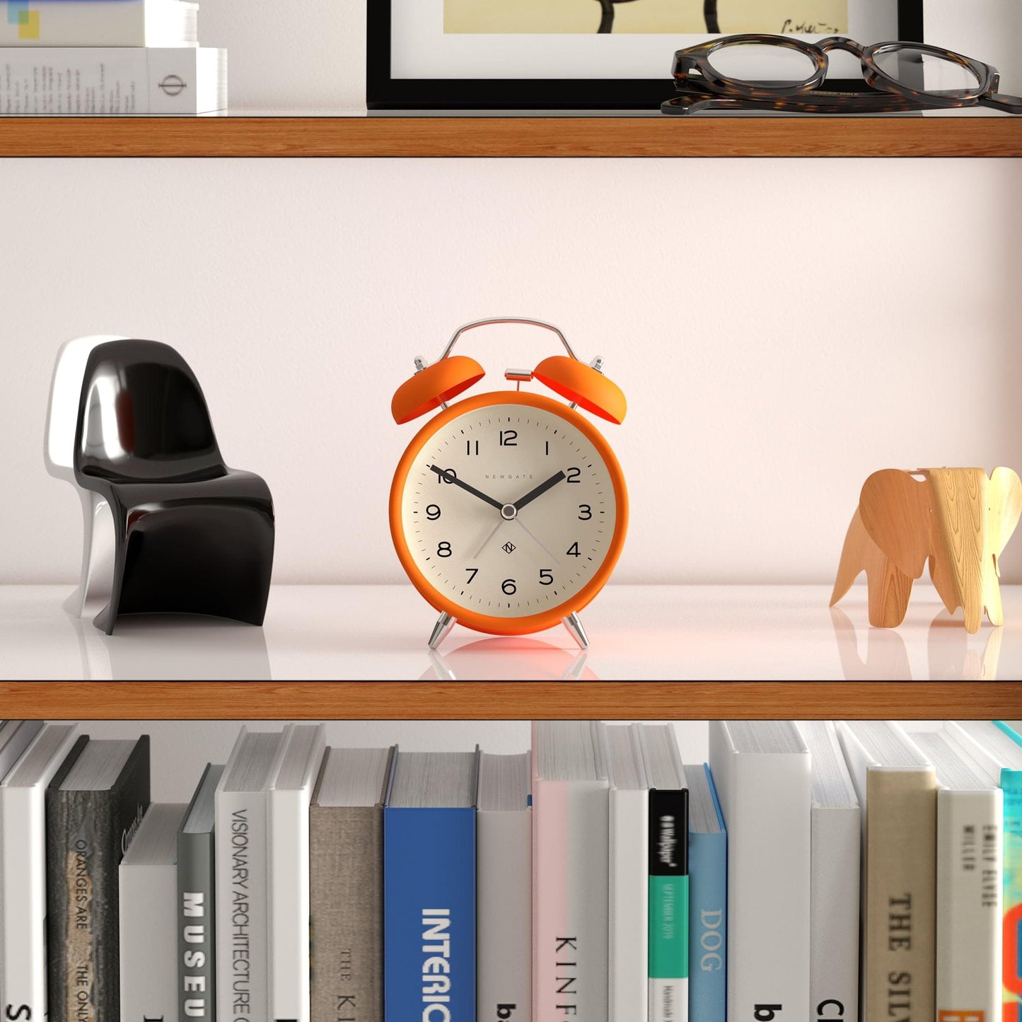 Orange matte alarm clock with twin bells and chrome frame, white dial with black hour markers