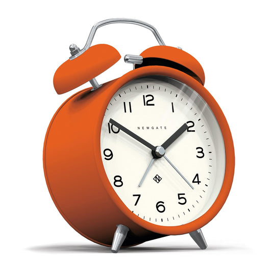 Orange matte alarm clock with twin bells, chrome feet and handle, white dial with black numbers
